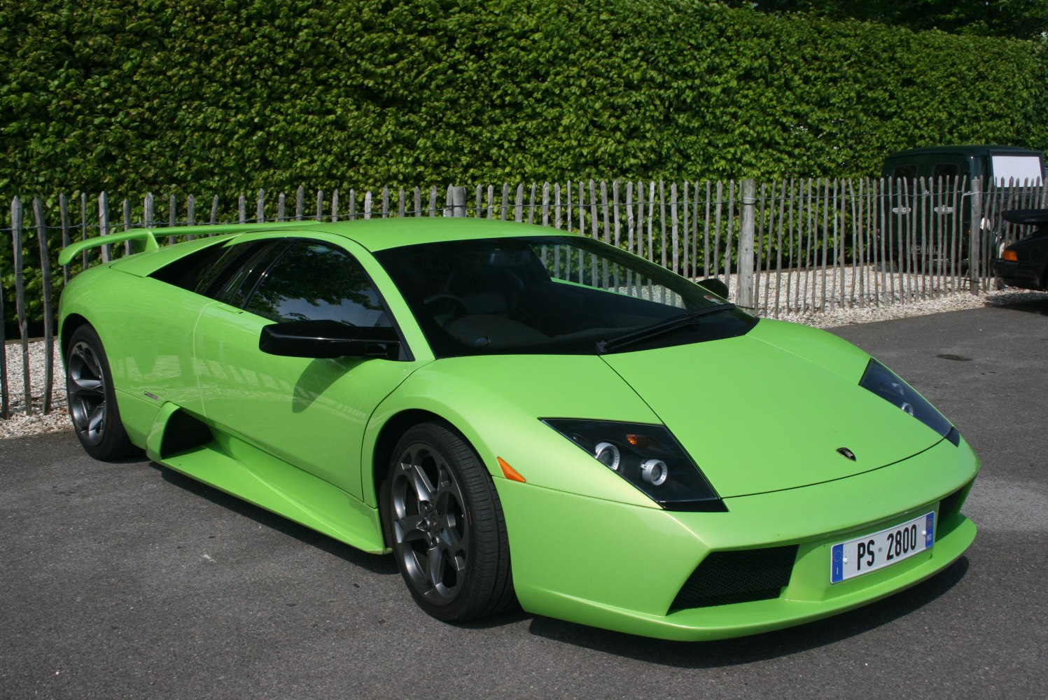 Green sports car with sleek aerodynamic design and rear spoiler