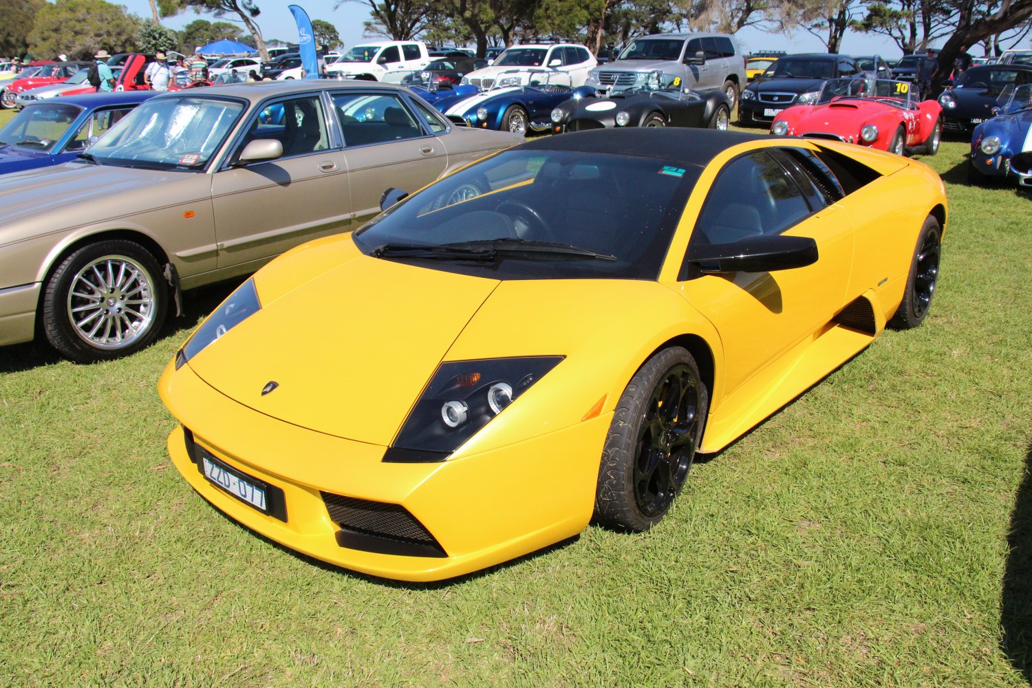 Yellow sports car with black roof and aerodynamic design