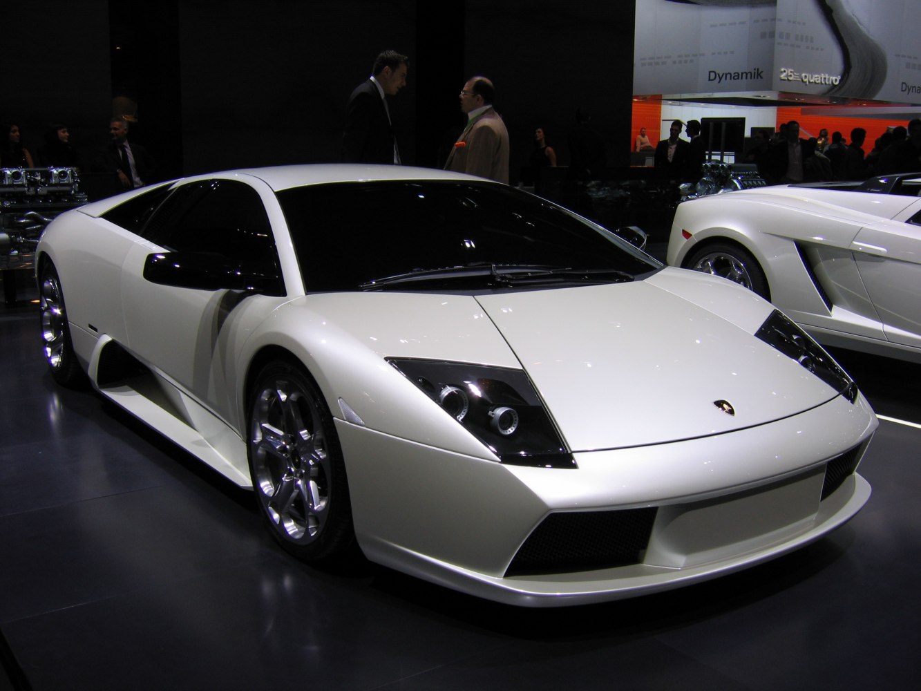 White sports car with angular headlights and polished alloy wheels