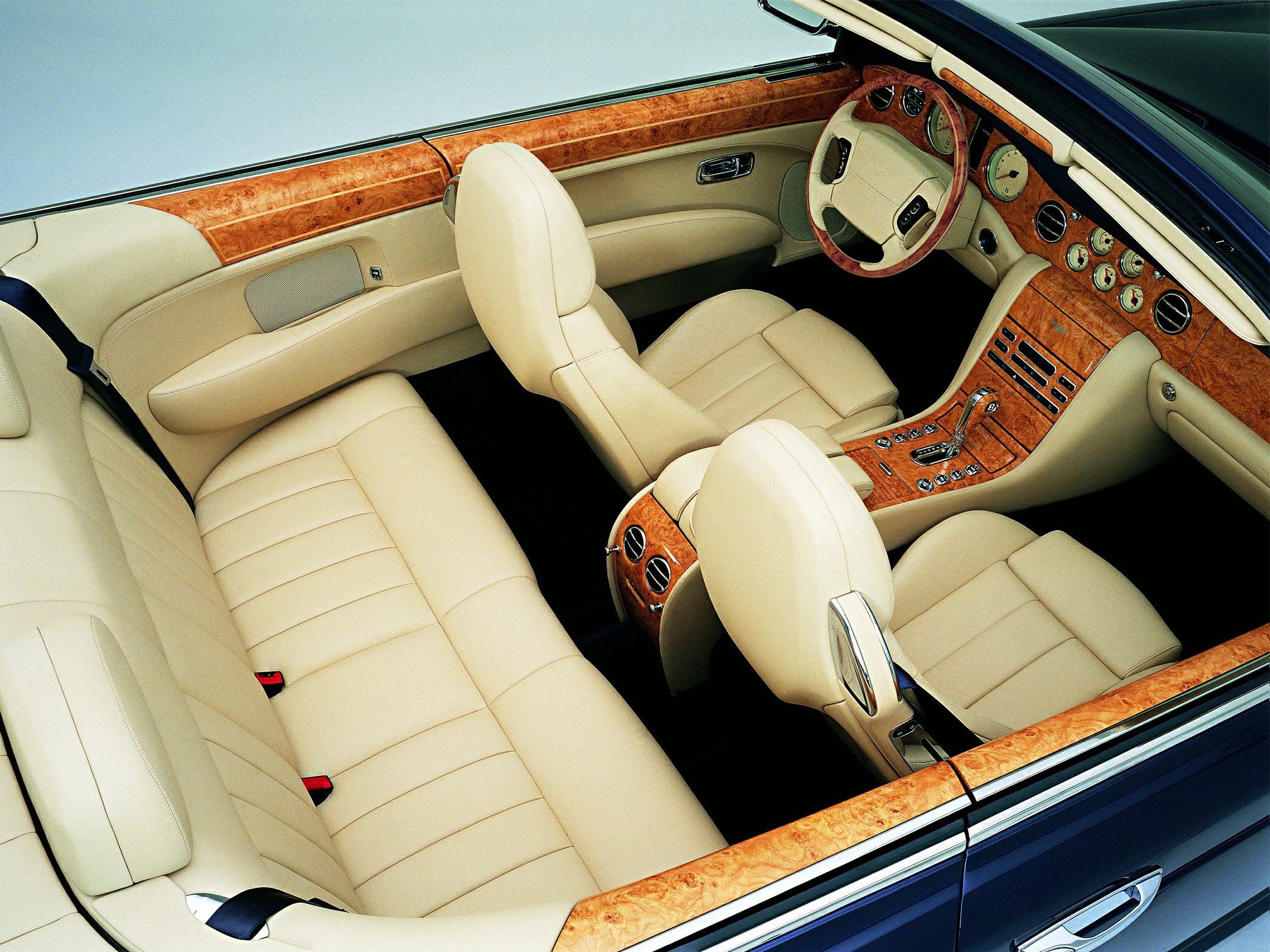 Beige leather seats and detailed wood trim interior with instrument dials.