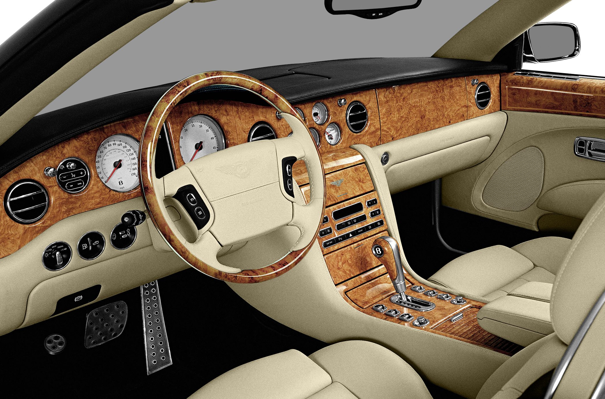 Luxury interior with wood trim, beige leather seats, and detailed dashboard