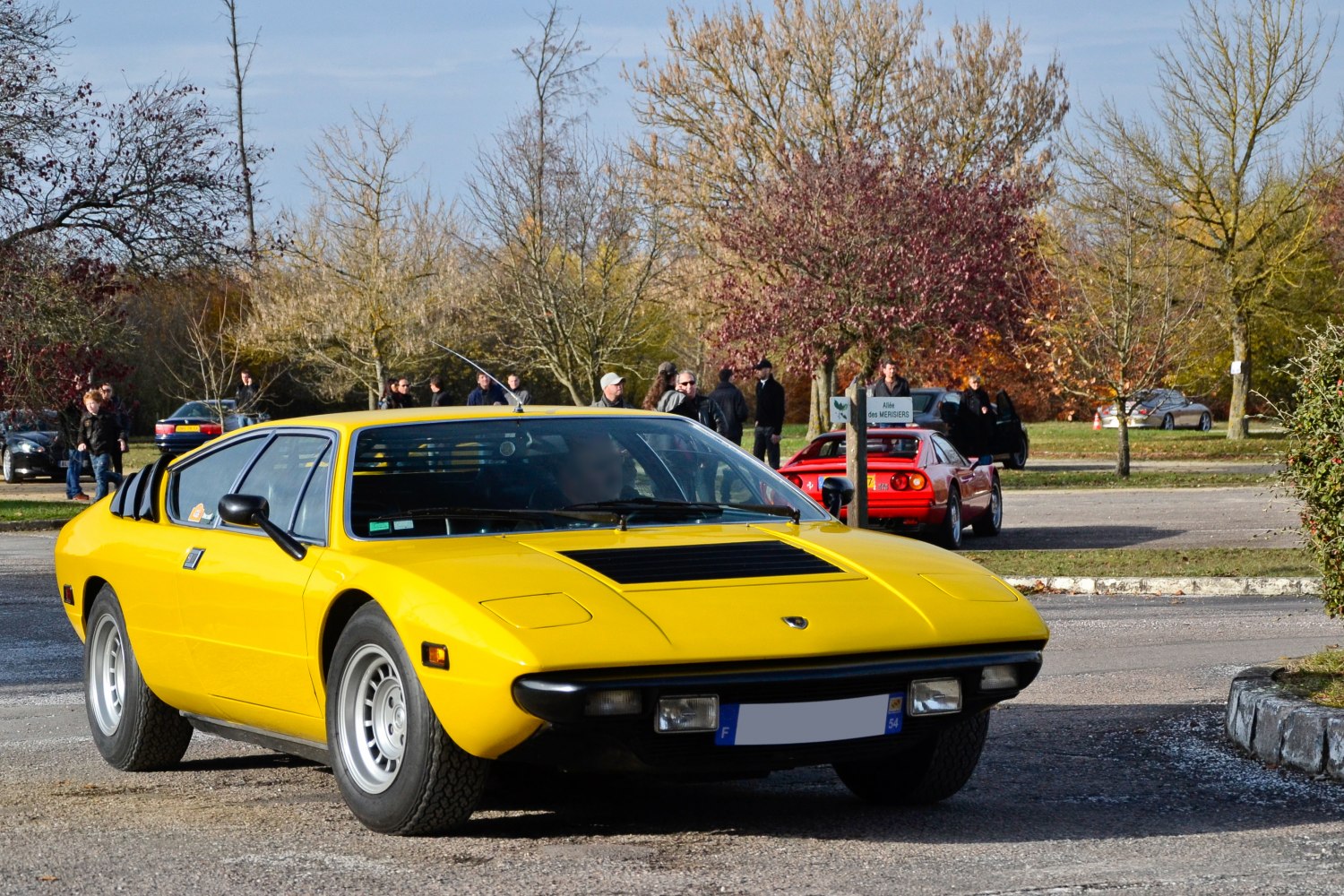 Pop-up headlights and rear window louvers on a vintage sports coupe