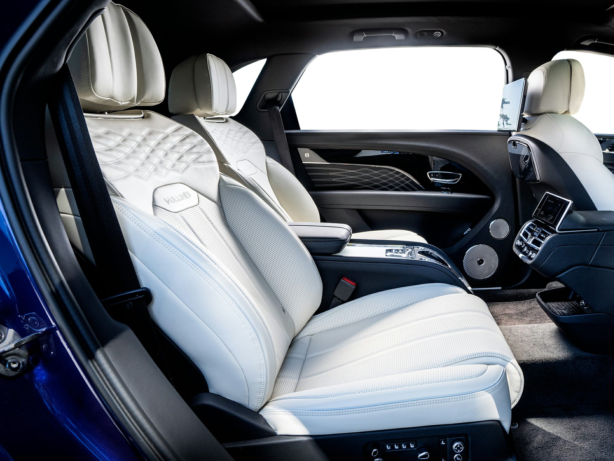White perforated leather seats with diamond stitching and premium rear interior details