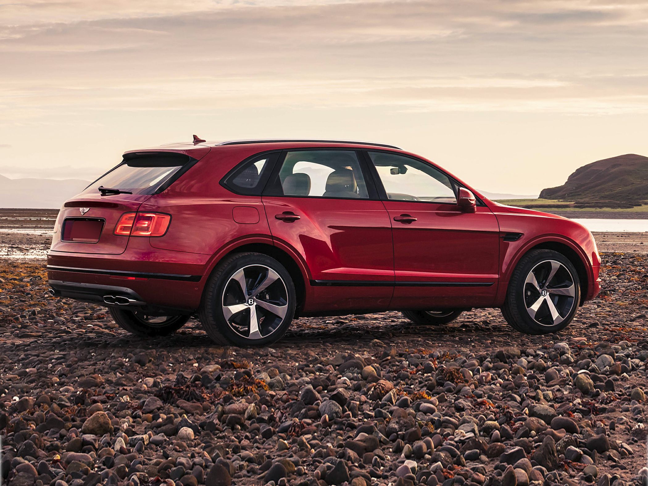 Luxury SUV side view with sleek design and distinctive alloy wheels