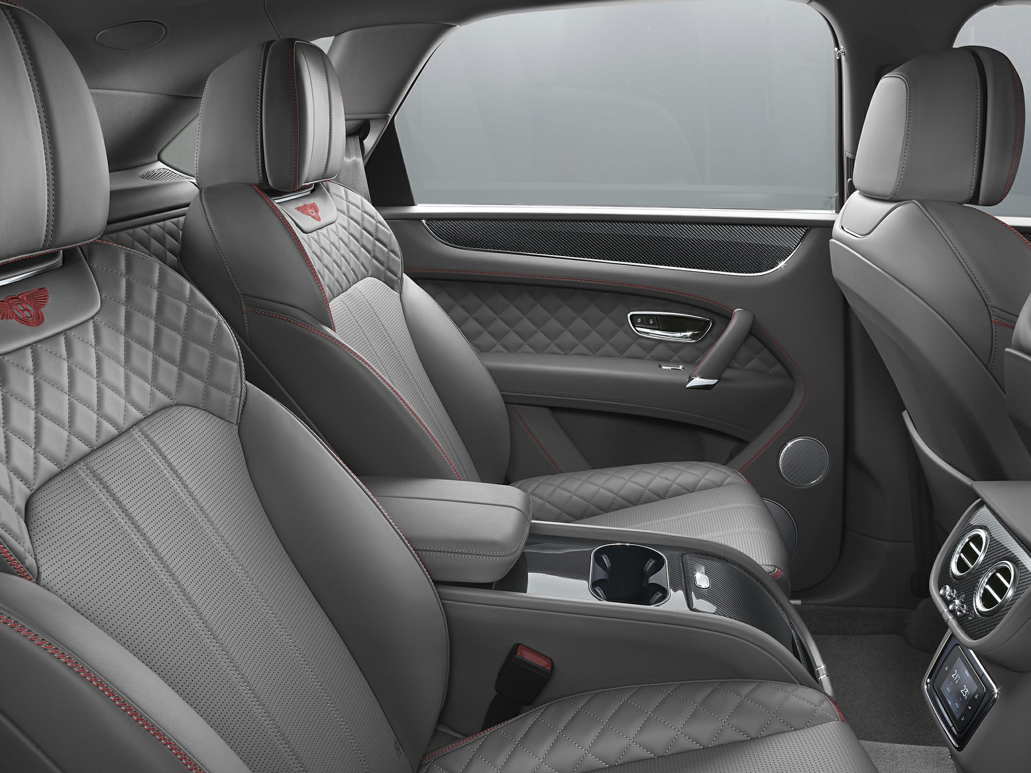 Quilted leather seats, carbon fiber trim, red stitching, center console with cupholders