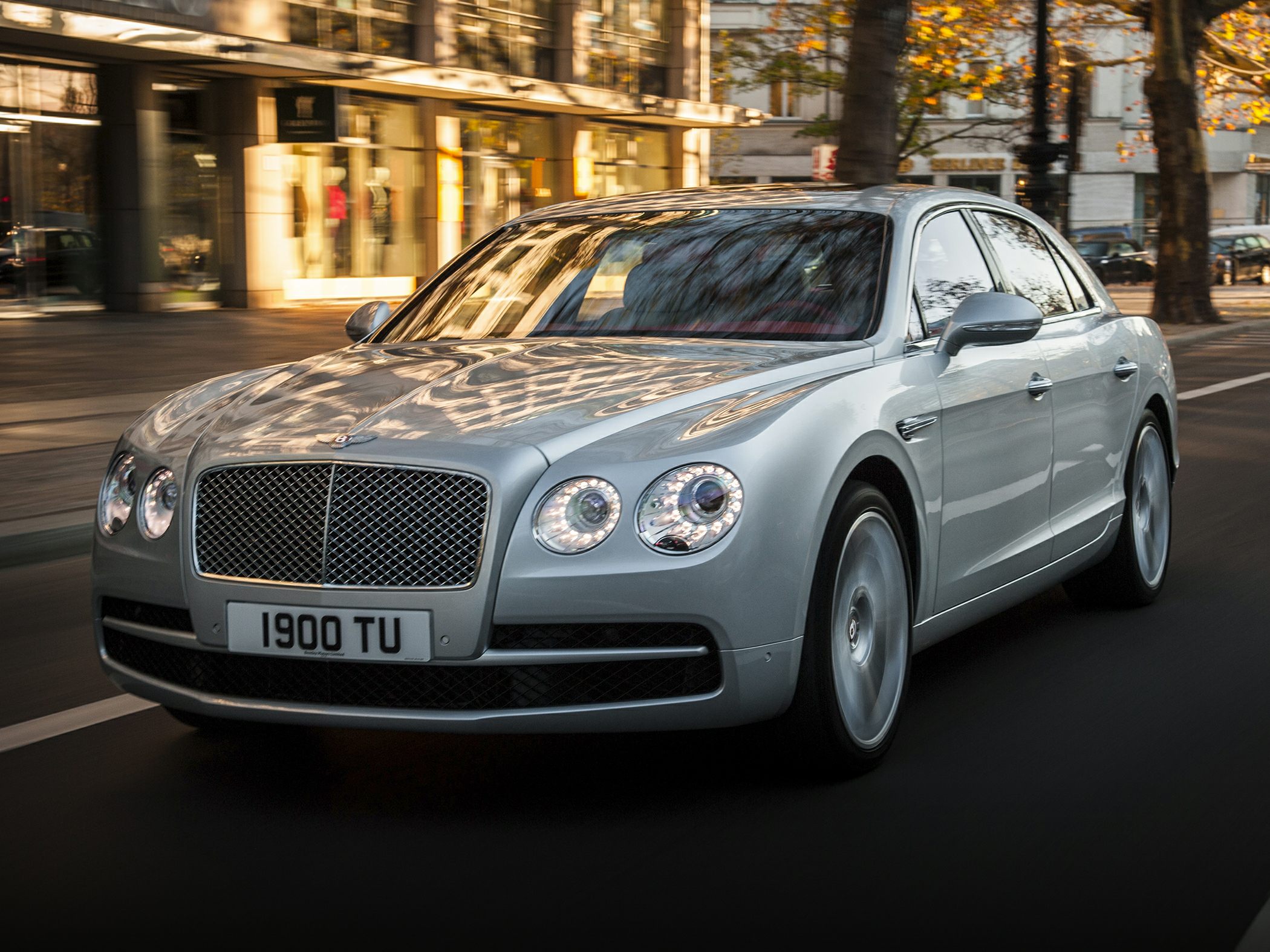Front view luxury sedan with LED ring headlights and chrome grille