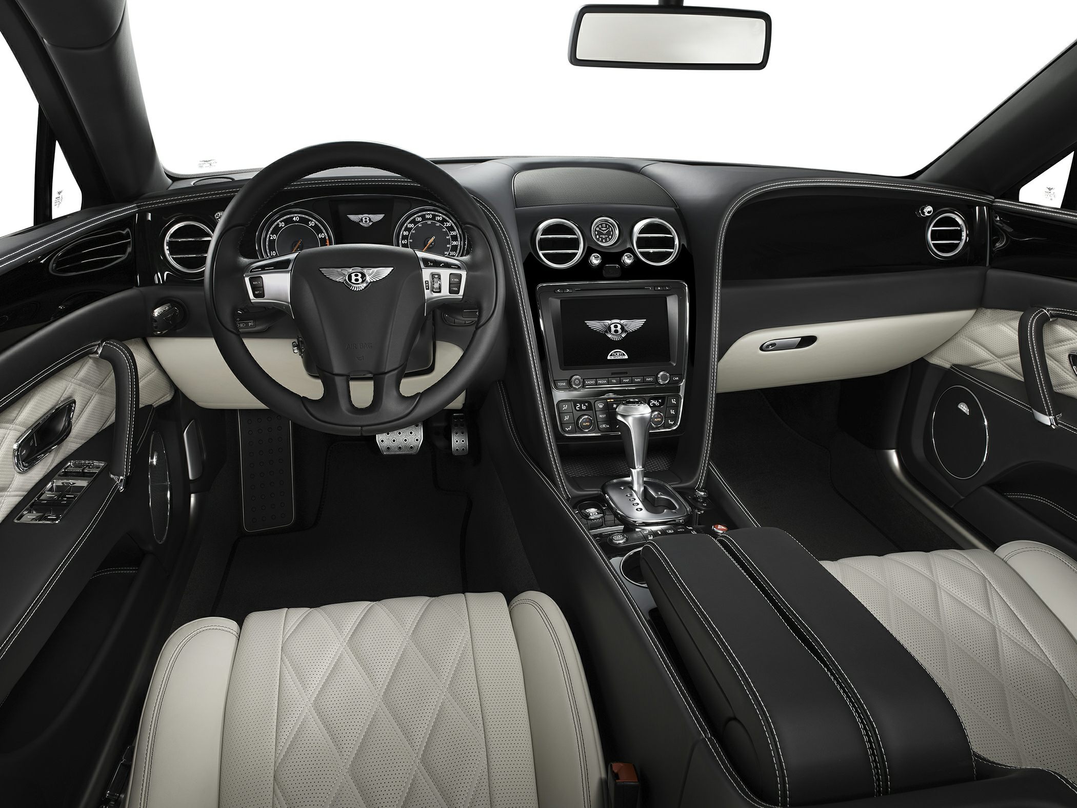 Luxury black and cream leather interior with detailed stitching and emblemmed steering wheel