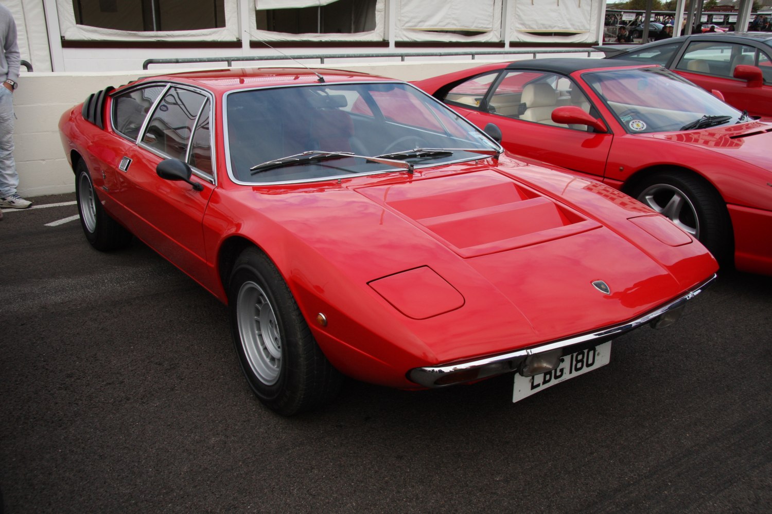 Red vintage sports coupe with pop-up headlights and sleek aerodynamic design