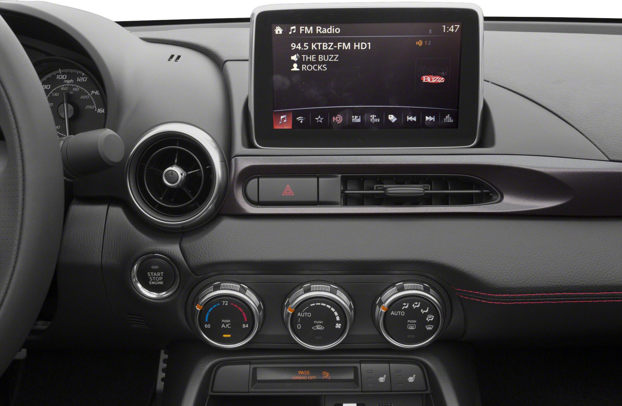 Infotainment touchscreen with climate control rotary dials on dashboard