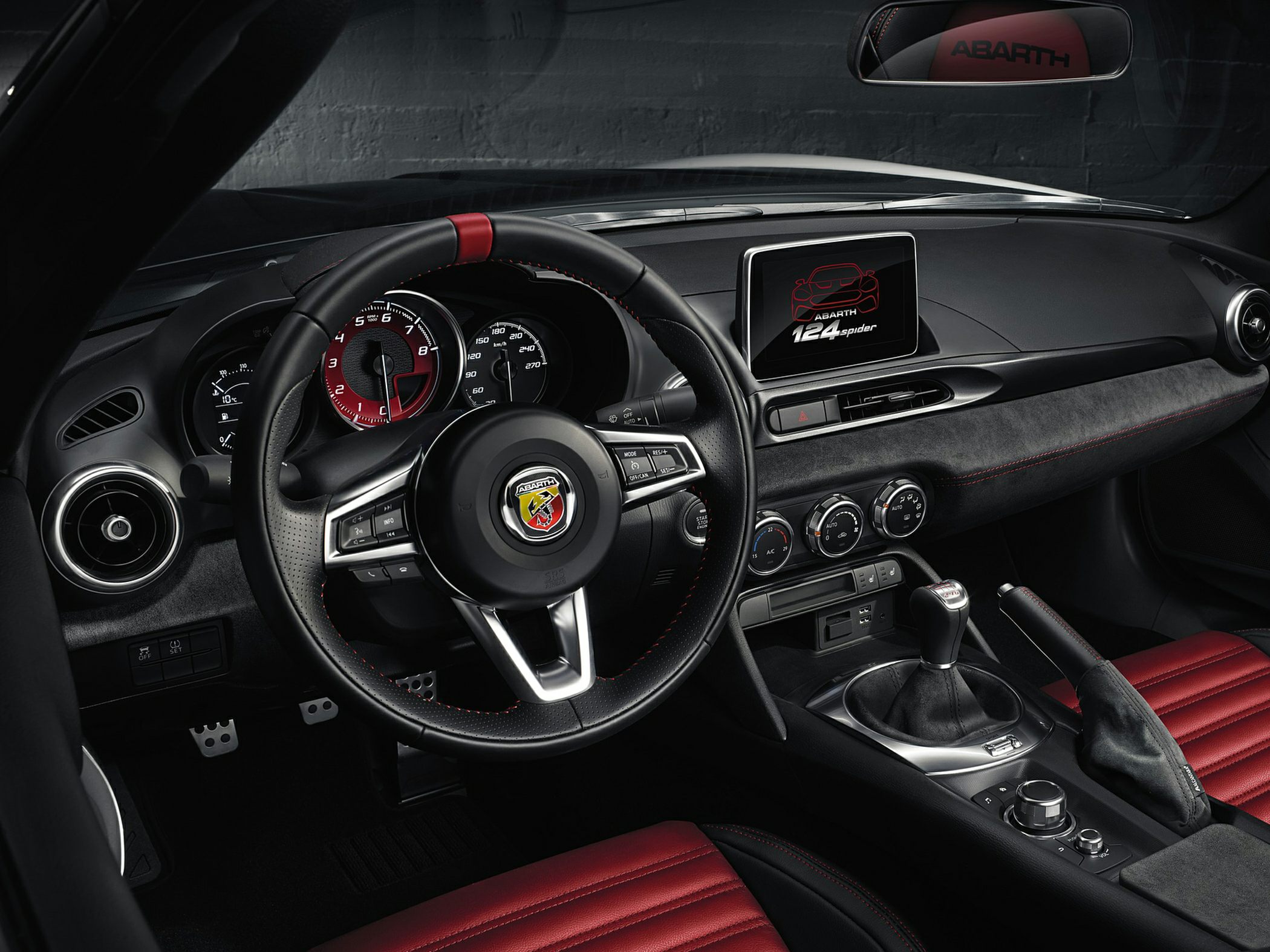 Black and red sporty car interior with manual transmission and digital display