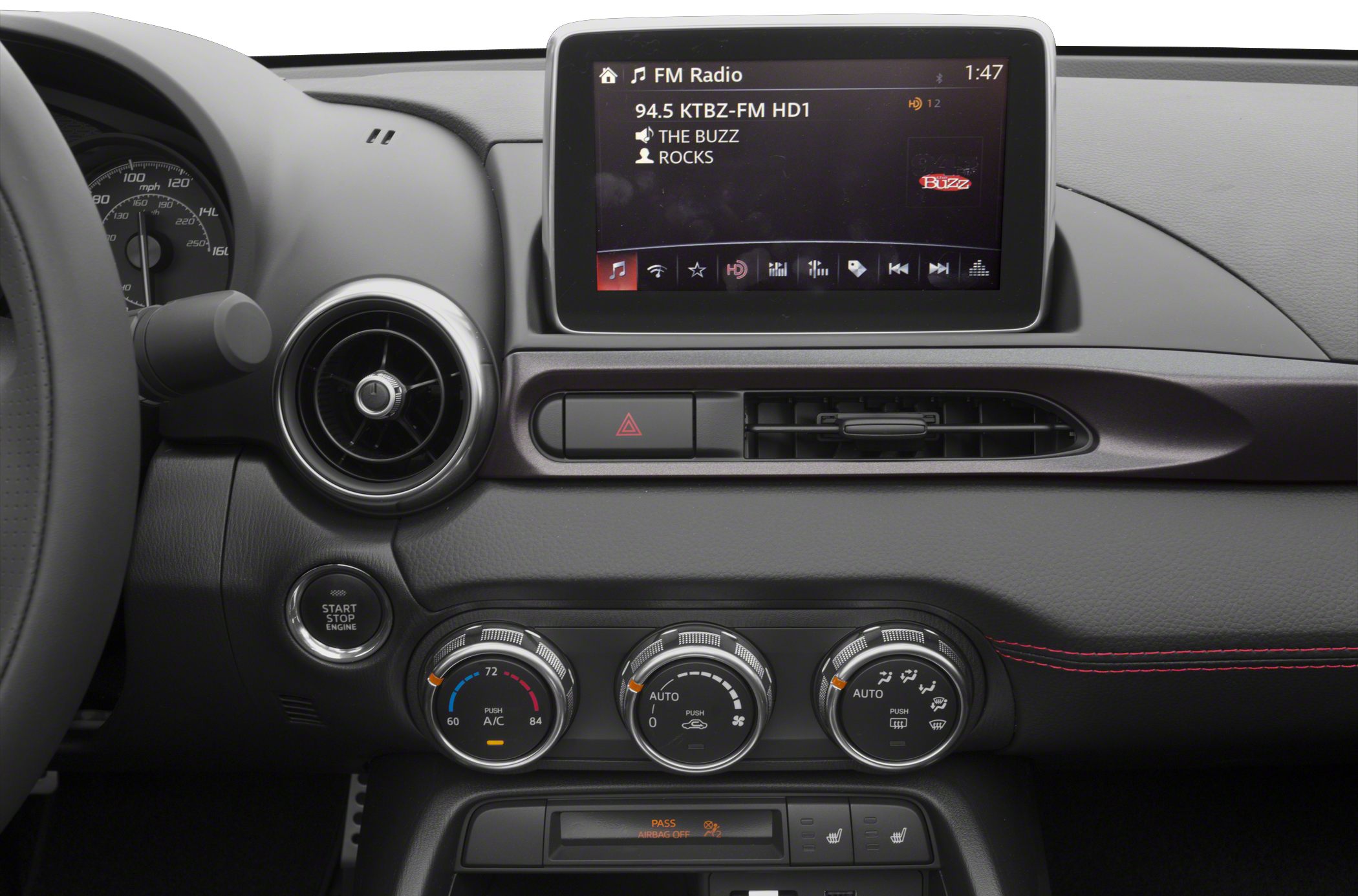 Dashboard with round climate control dials, digital infotainment screen, and engine start button