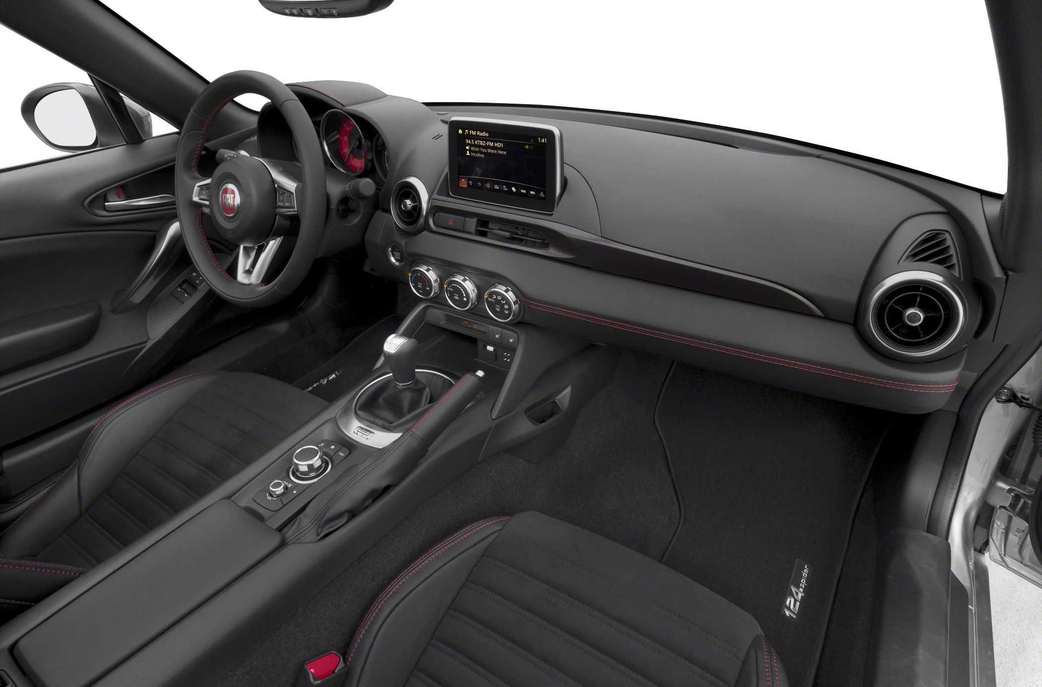 Modern dashboard with touchscreen, manual gear lever, and rotary controls