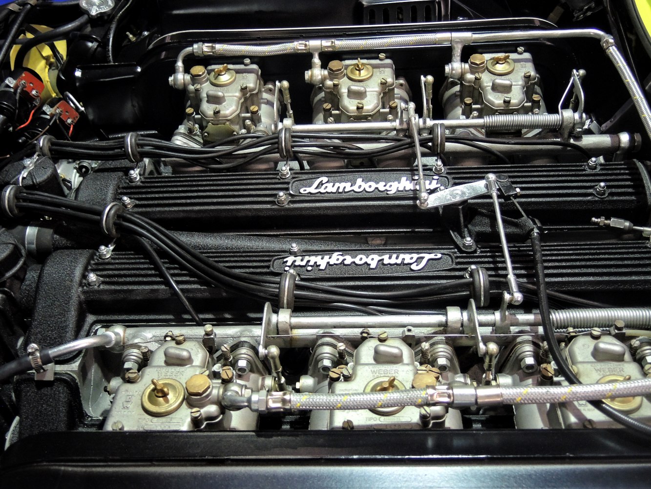 Close-up of vintage Lamborghini V12 engine with carburetors and wiring