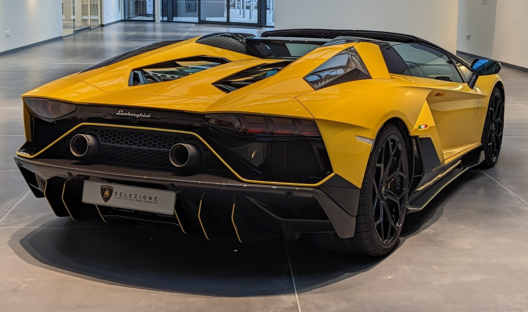 Rear exhaust and diffuser with dual round tailpipes and aggressive aero styling