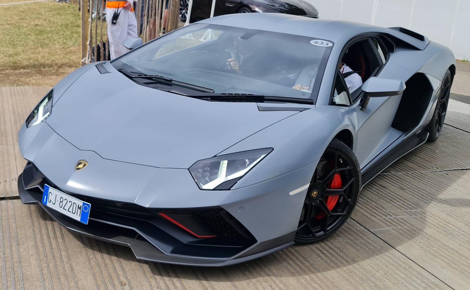 Sharp LED headlights and aerodynamic front with black rims and red brake calipers
