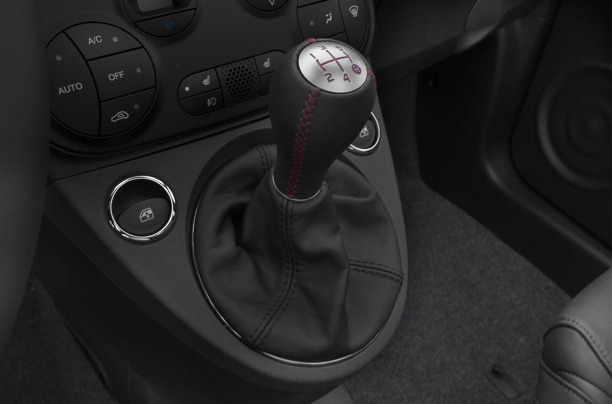 Manual gear shift lever and car interior controls.