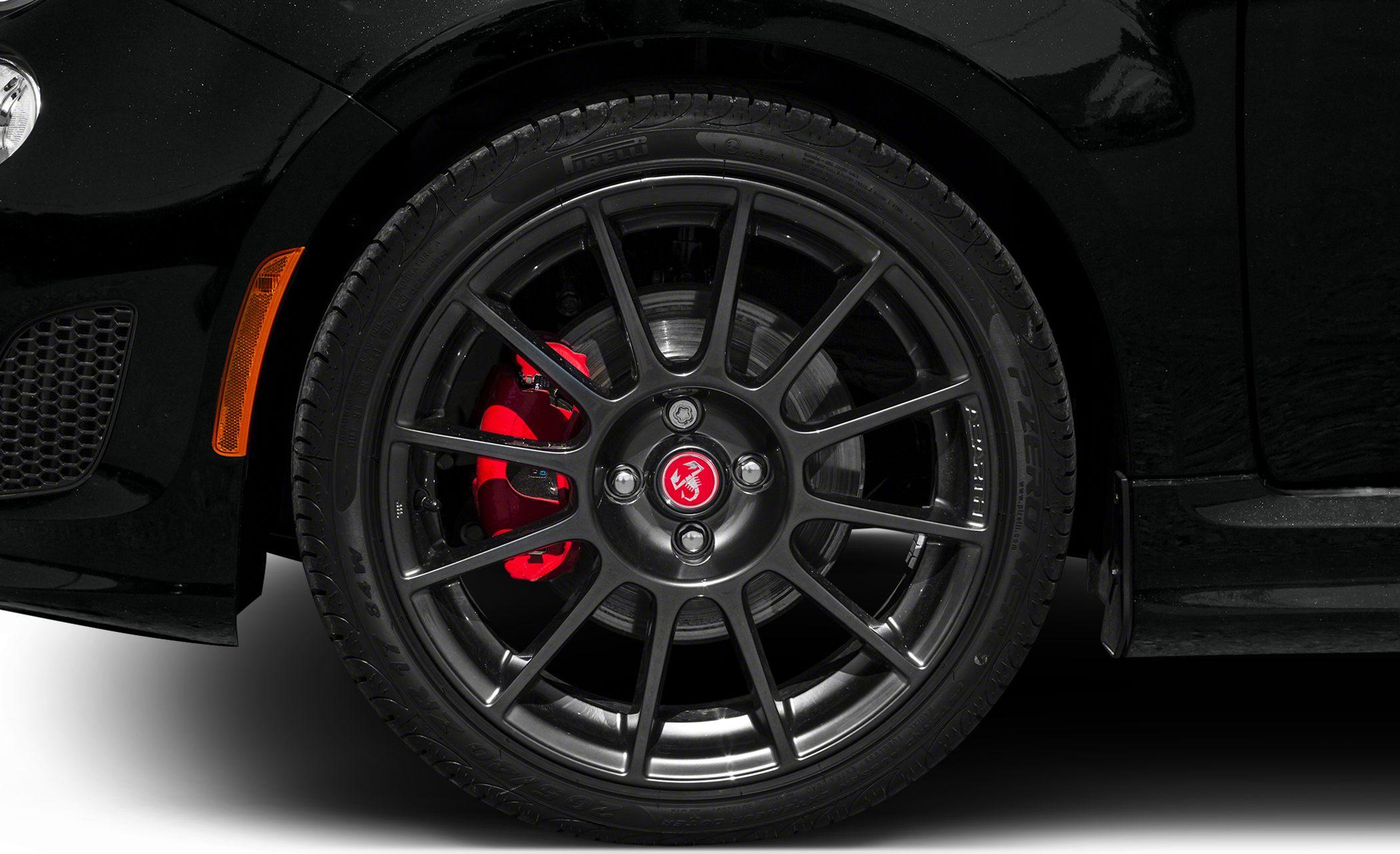 Black multi-spoke wheel with red brake caliper