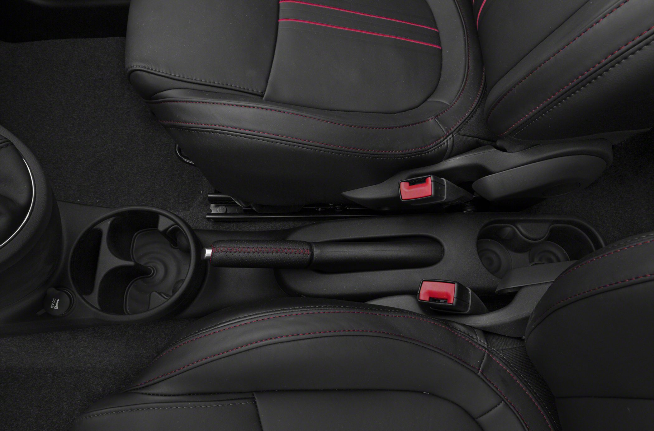 Interior center console with handbrake, cup holders, and black leather seats with red stitching