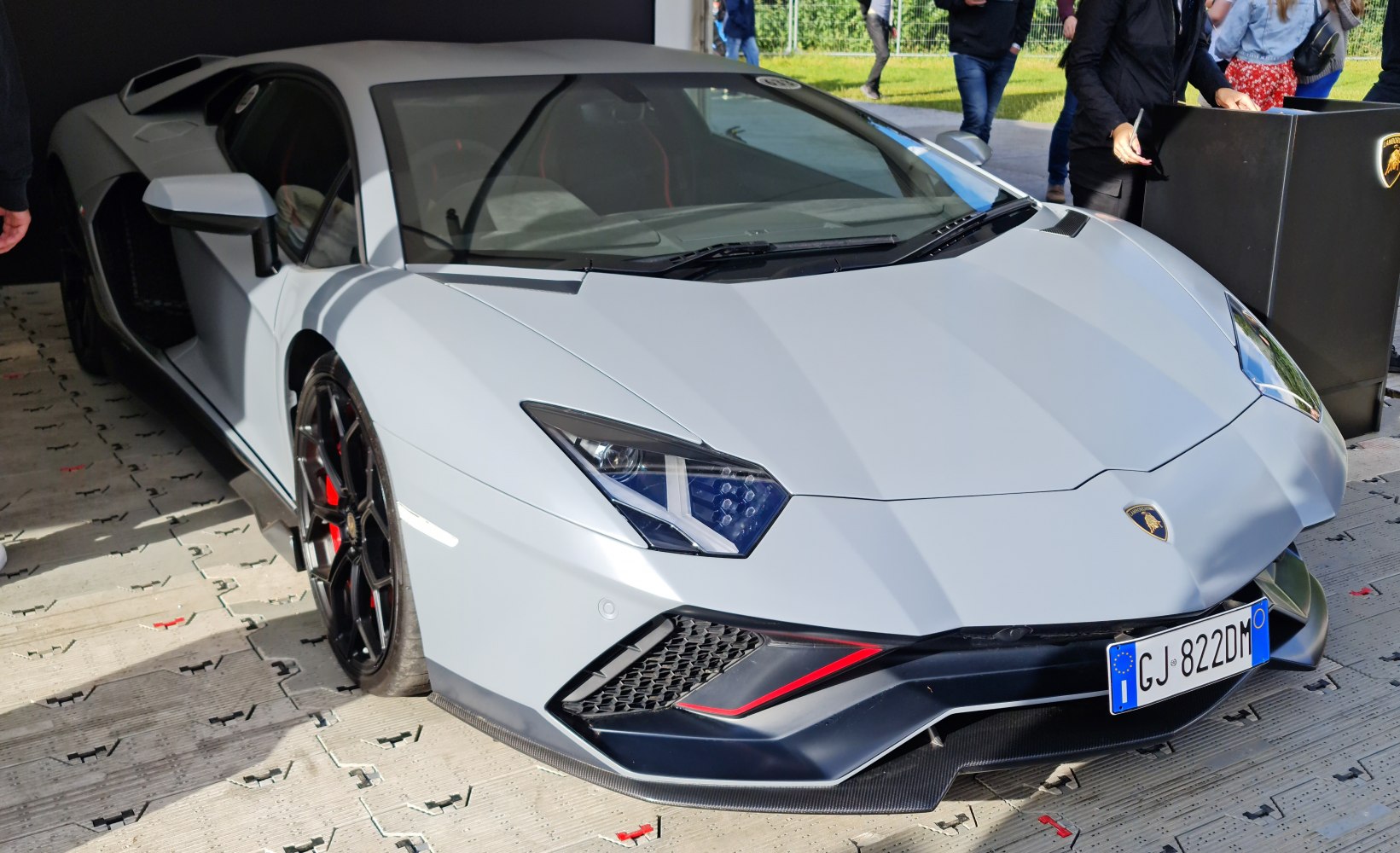 Aggressive headlights and aerodynamic front splitter in supercar front view
