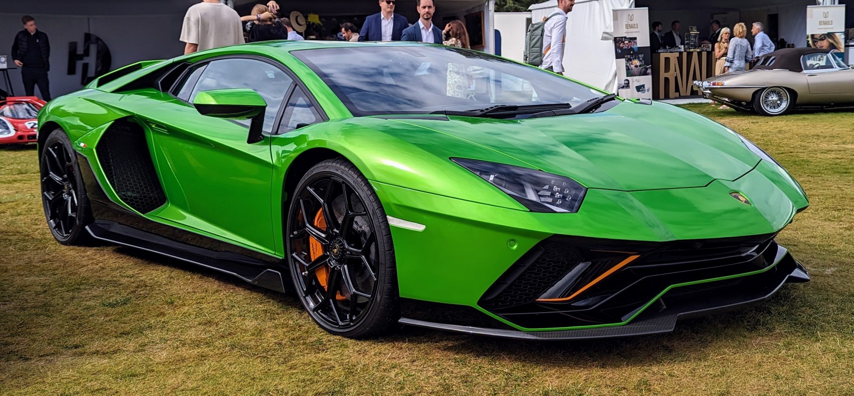 Green sports coupe with sharp aerodynamic front and black multi-spoke wheels