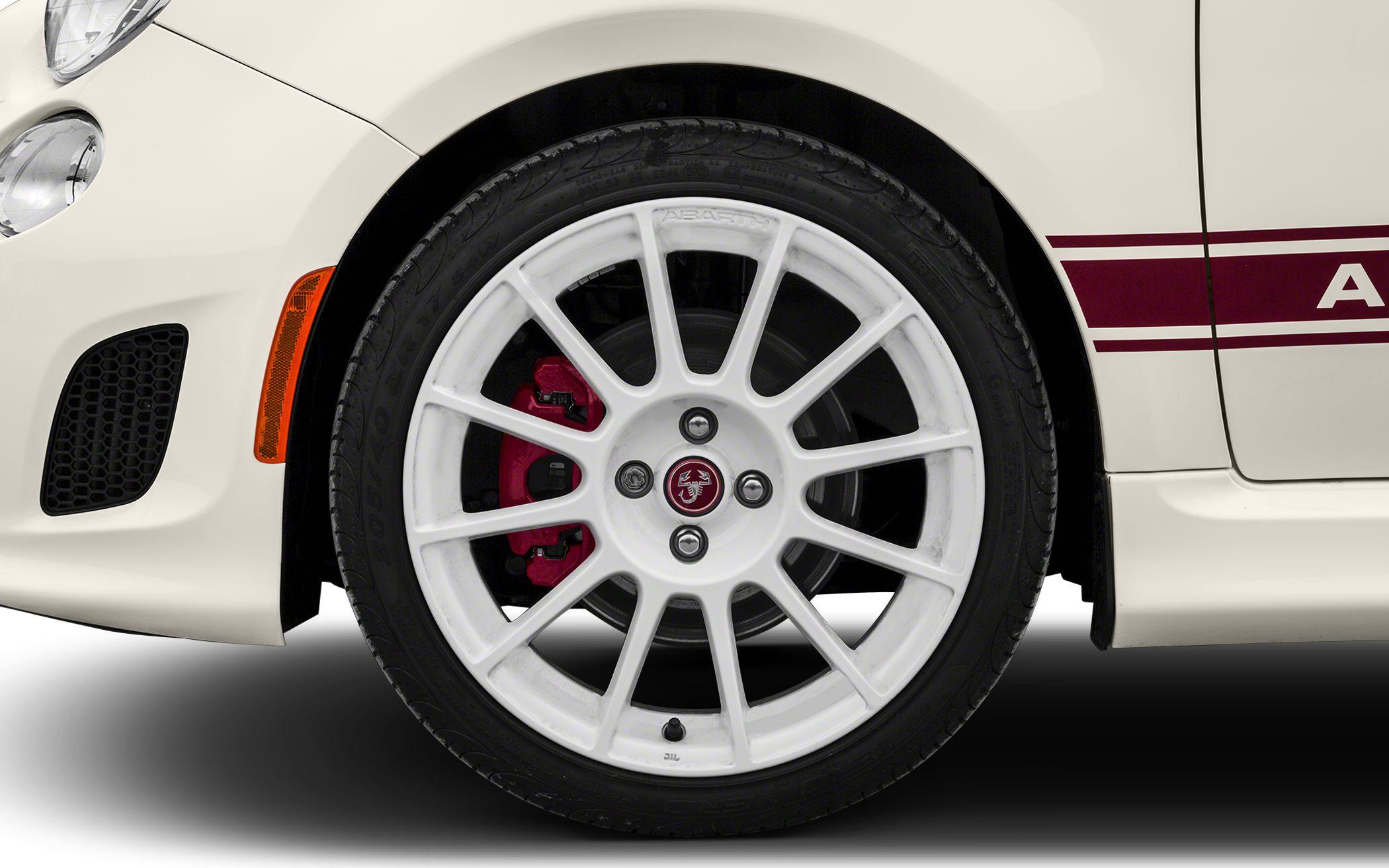 White multi-spoke alloy wheel with red brake caliper and side marker light