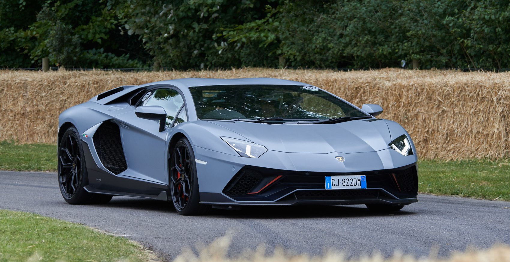 Matte grey supercar with angular lines and aggressive front aerodynamic elements