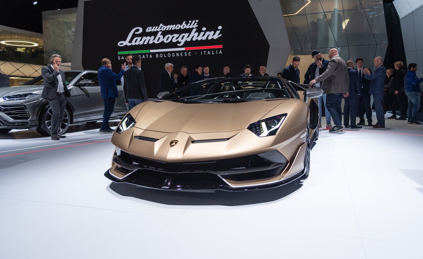 Close-up on front end and angular headlights of a luxury convertible supercar.