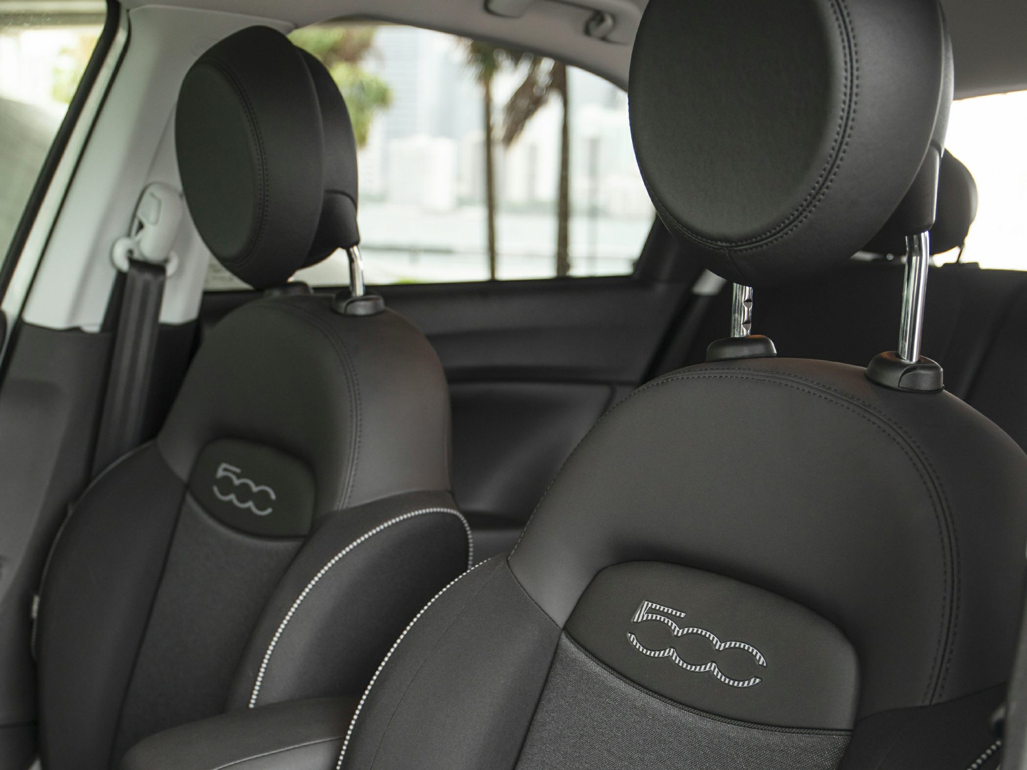 Close-up of black front seats with 500 logo embroidery