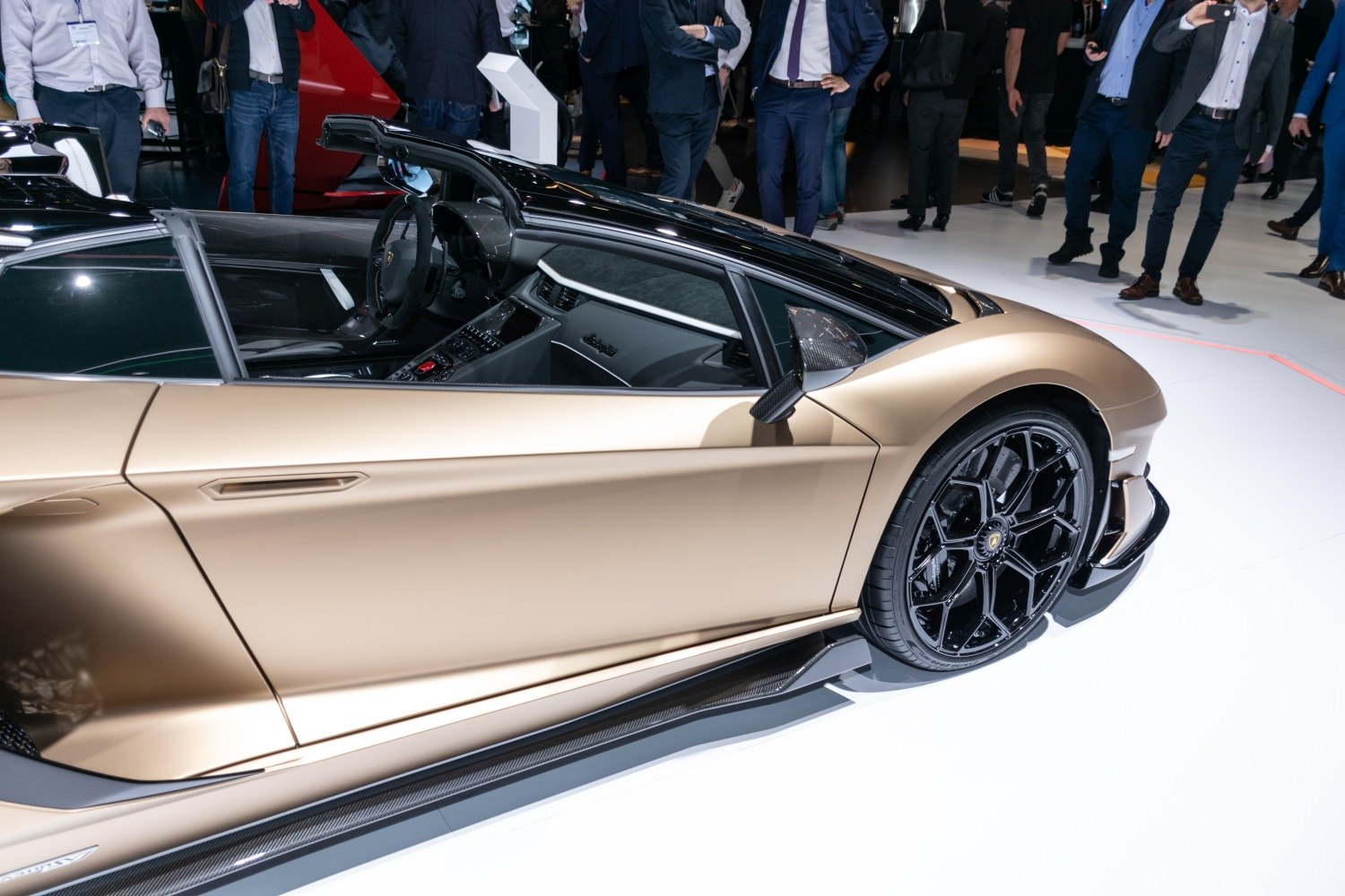 Side profile with black alloy wheels and visible interior cockpit
