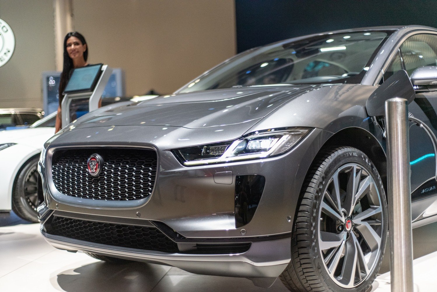 Front view of electric SUV with LED headlights and charging plug