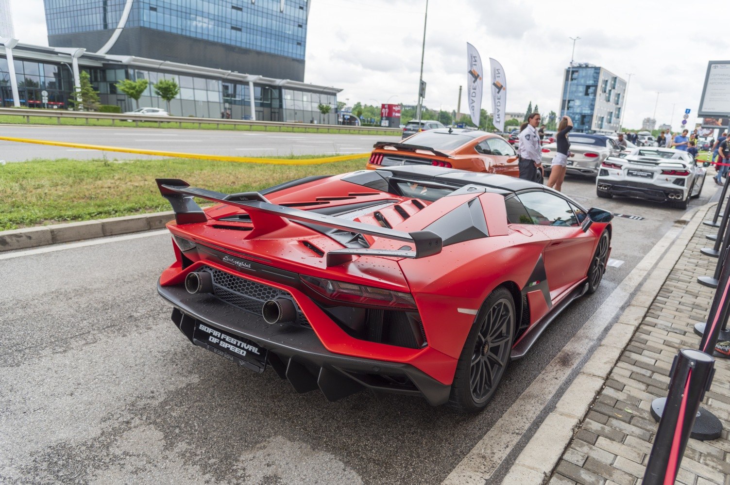 Rear view of a sports car with aggressive rear wing and dual exhausts.
