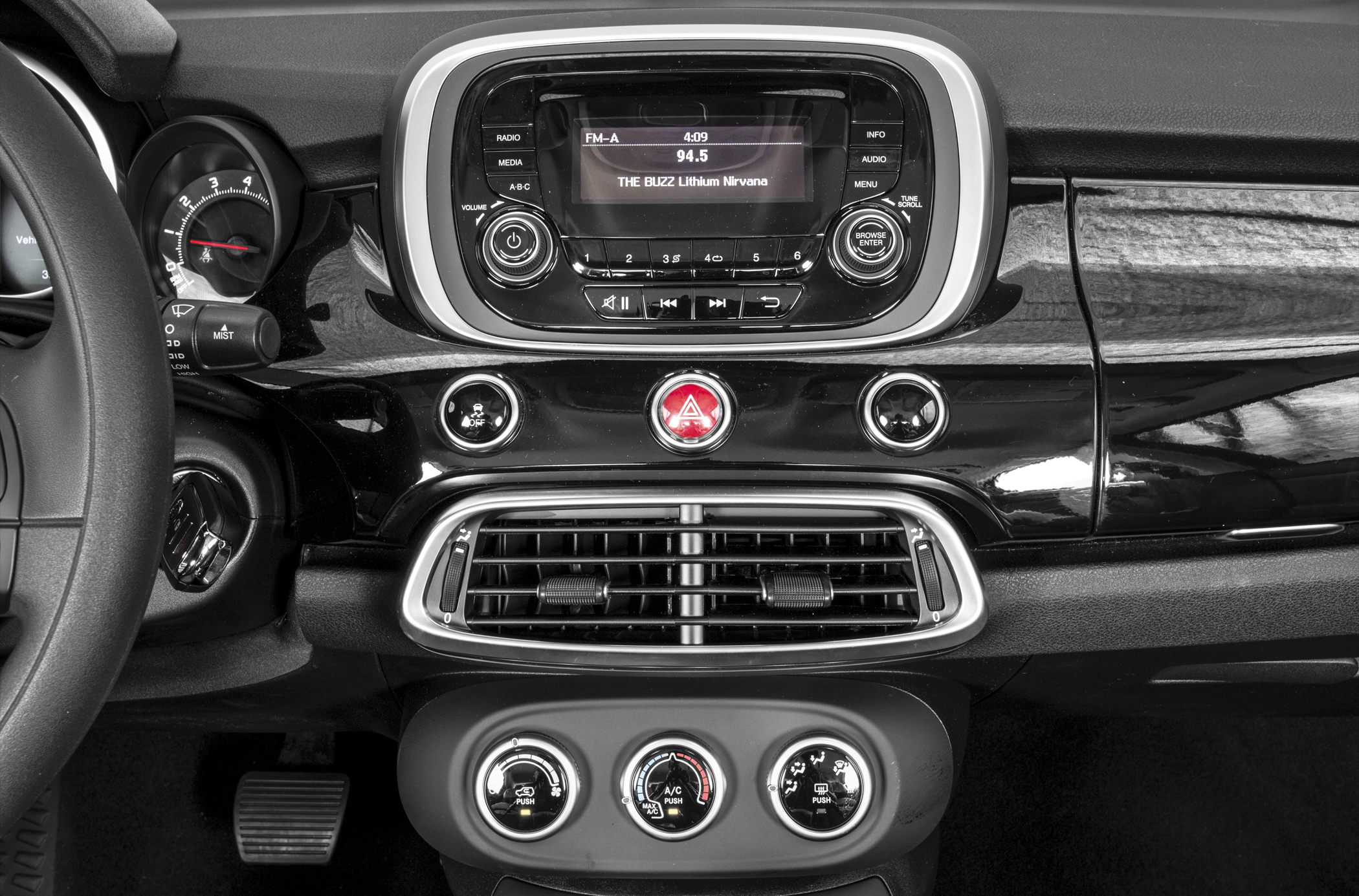 Dashboard with audio system, air vents, and climate control knobs