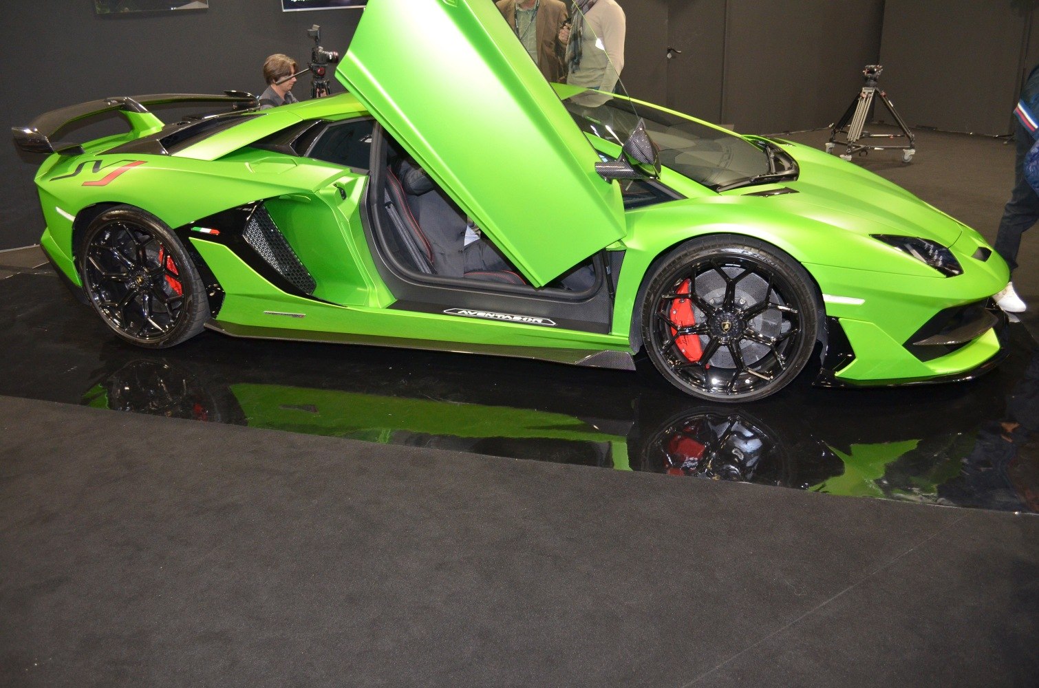 Signature scissor door open, black multi-spoke wheels, carbon fiber accents