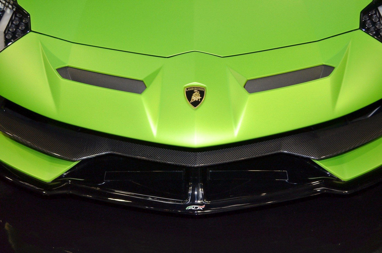 Close-up of front hood with sharp lines and carbon fiber splitter