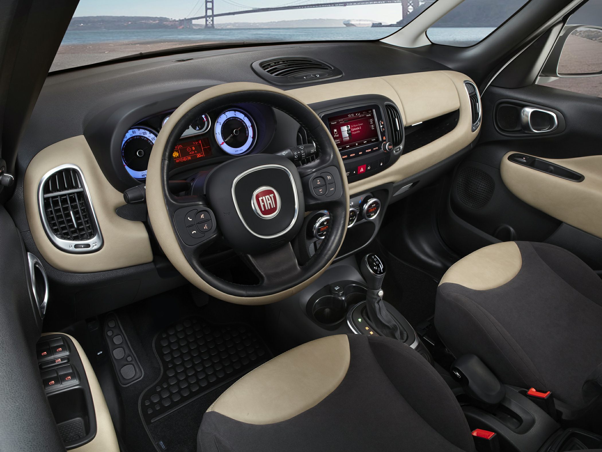 Beige-accented dashboard with steering wheel, instrumentation, and infotainment system
