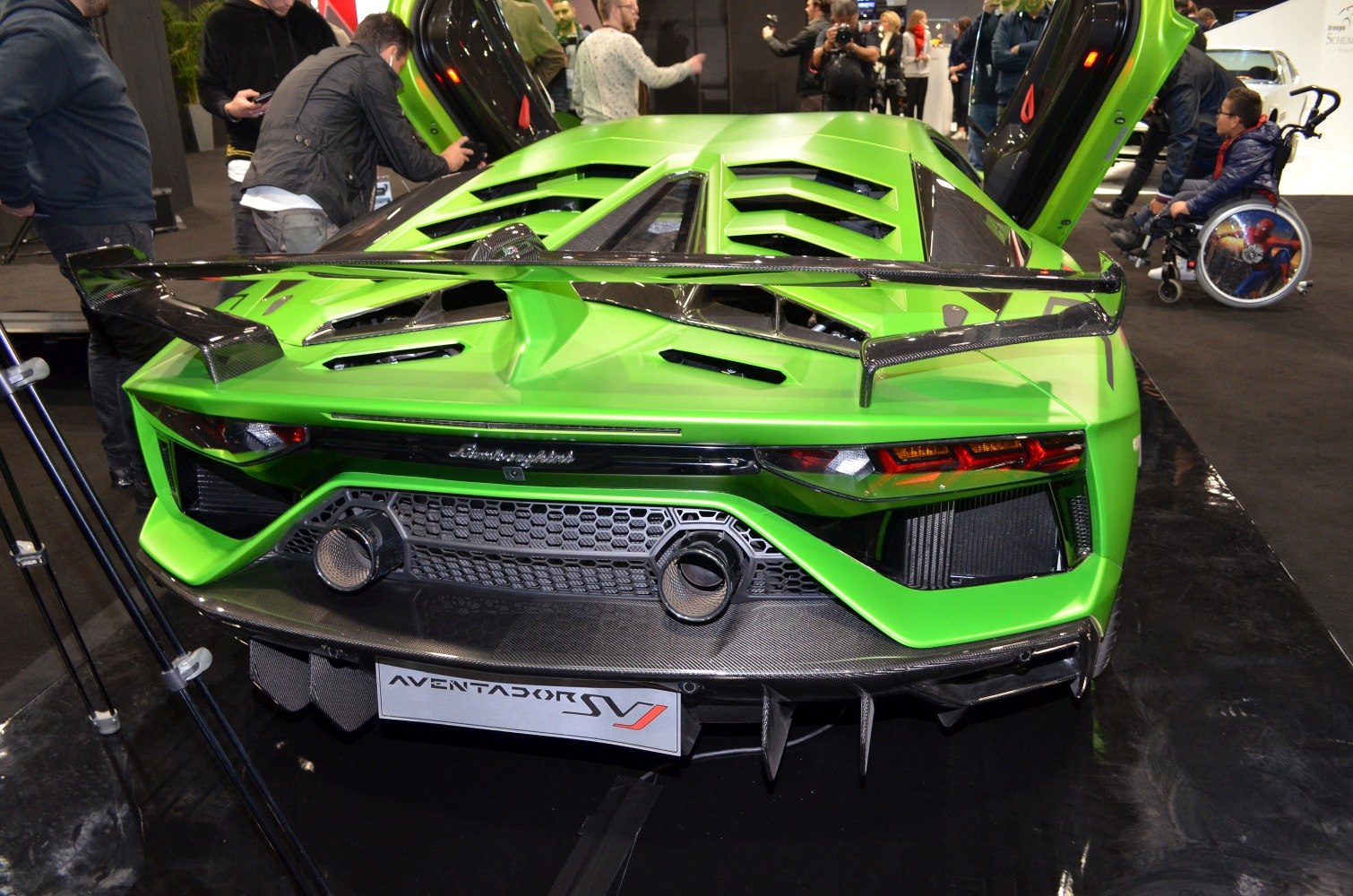 Rear view with large carbon fiber spoiler and aggressive exhaust design
