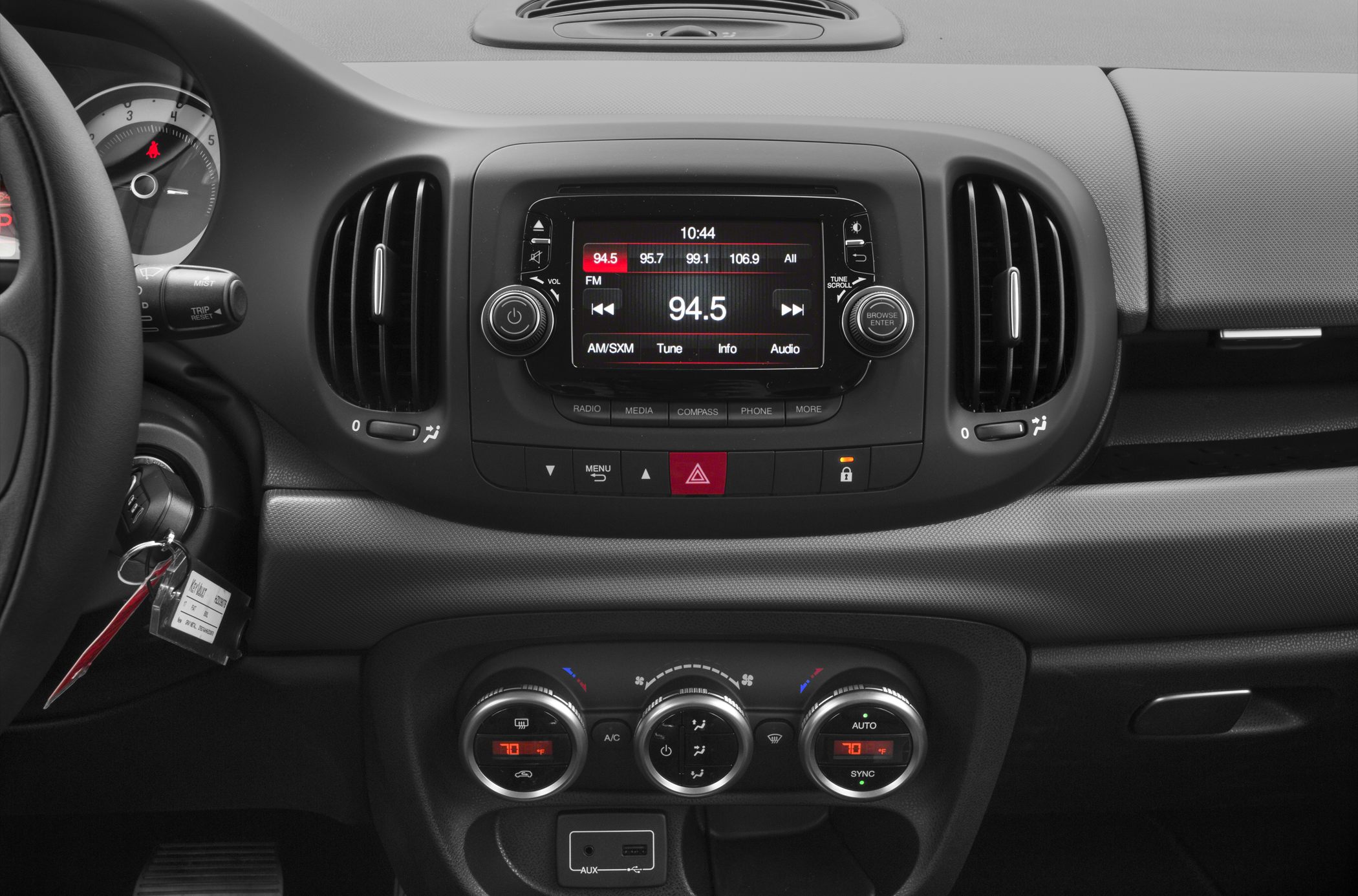 Infotainment system and climate control knobs on car dashboard