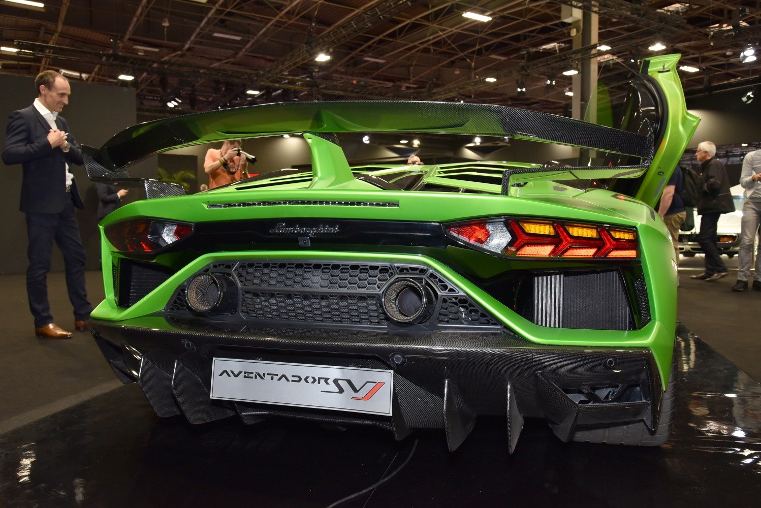 Rear exhausts, LED tail lights and carbon fiber wing of a supercar