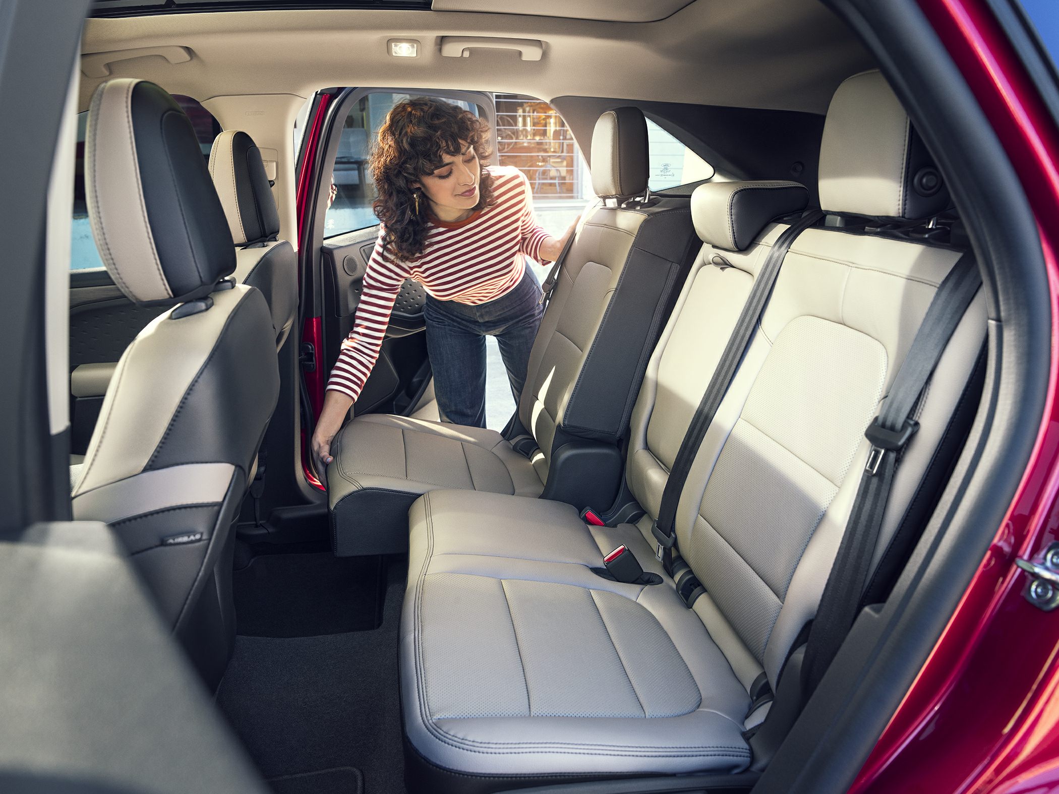 Rear seat folding mechanism with beige upholstery and seating layout