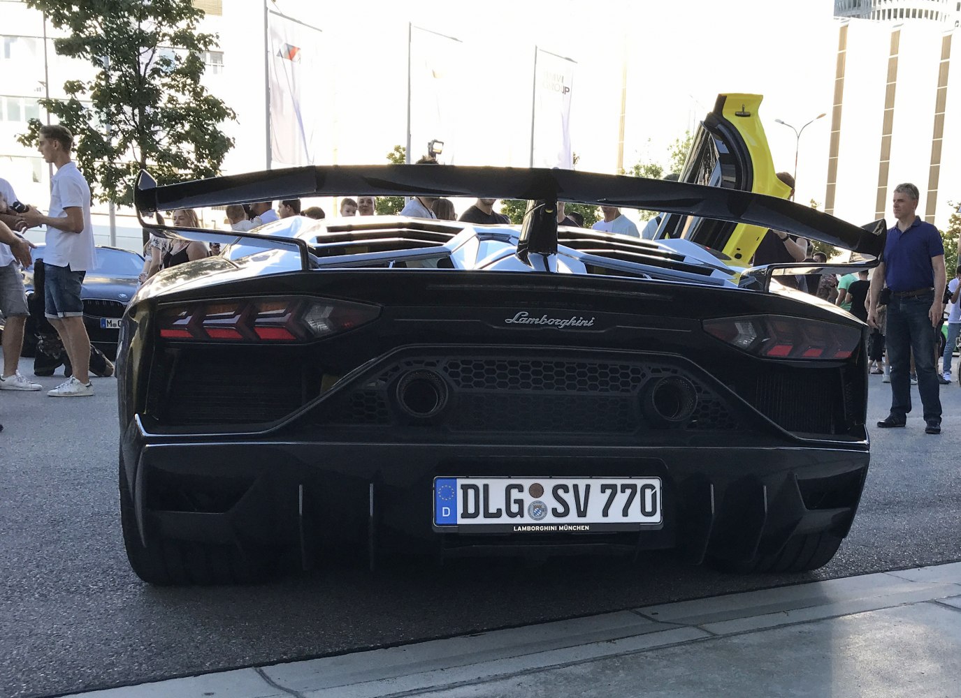 Rear view with large aerodynamic wing and hexagonal exhaust outlets.