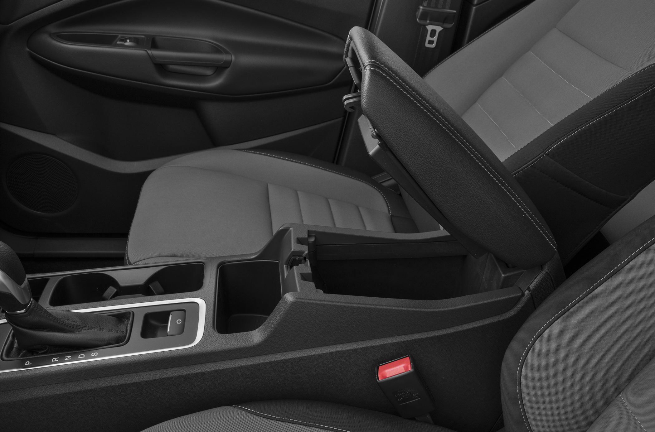 Center console with gear shifter, armrest storage, cup holders