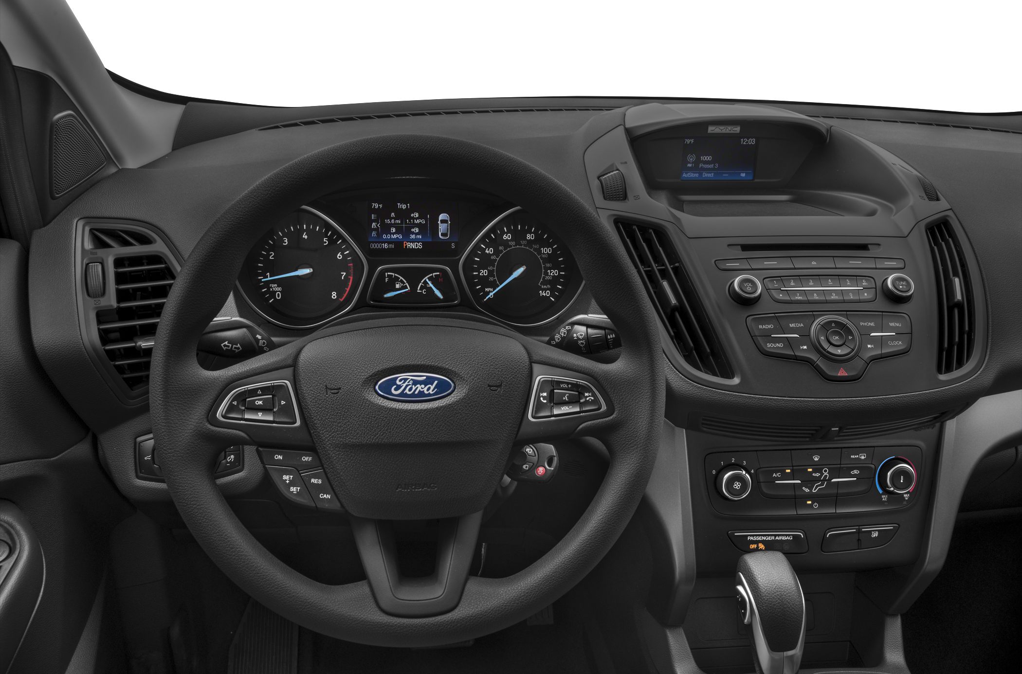 Close-up of dashboard, steering wheel, and center console with control buttons and display screens.
