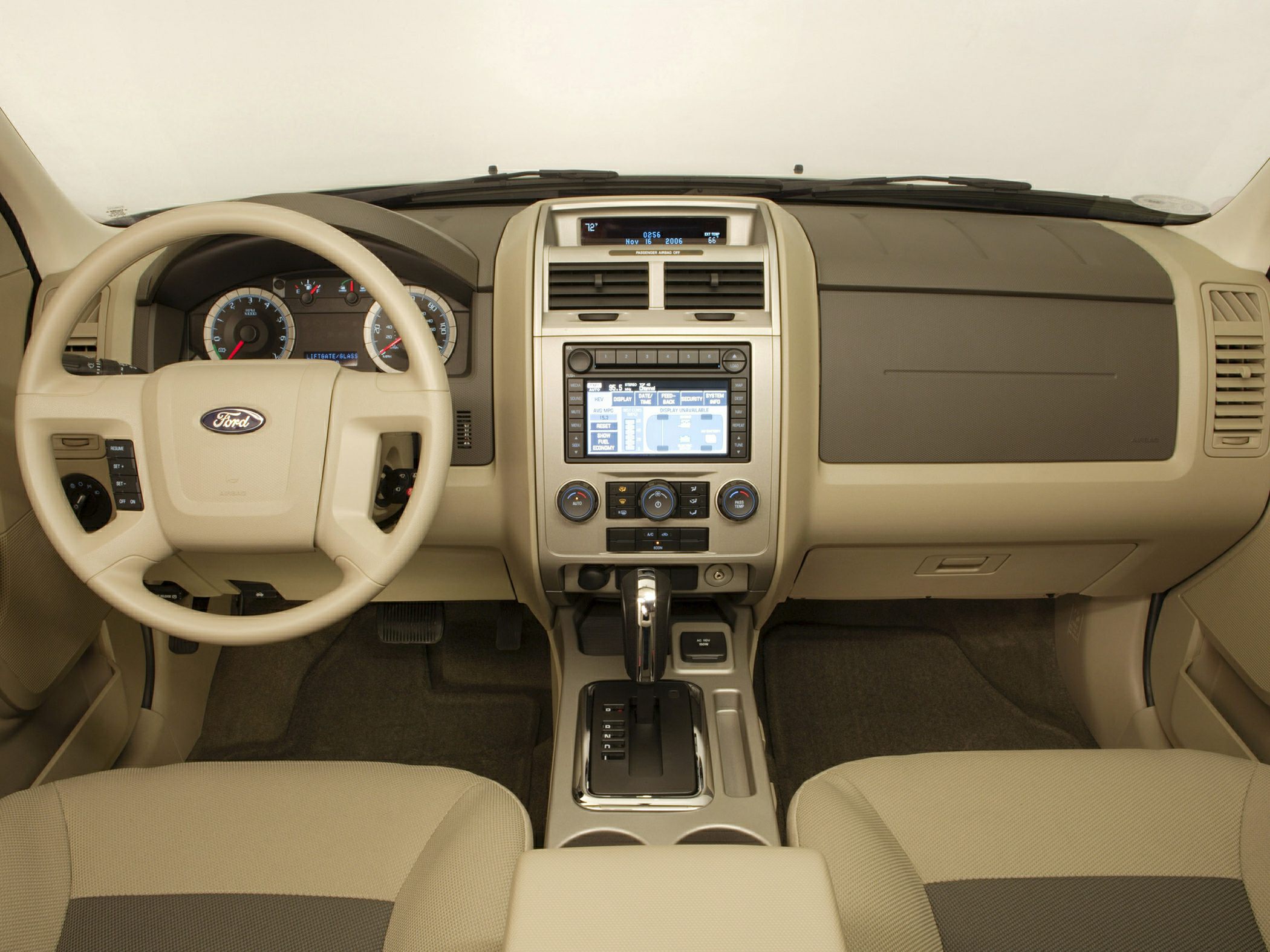 Beige dashboard, steering wheel, and center console with integrated display and controls.