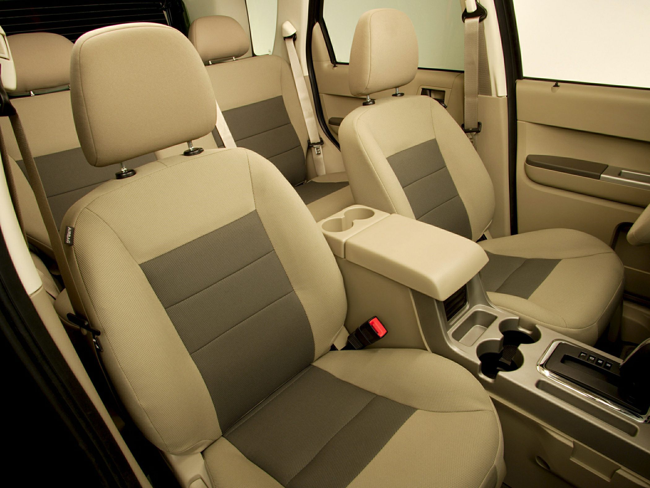 Beige and gray fabric front and rear seats with center console and cup holders