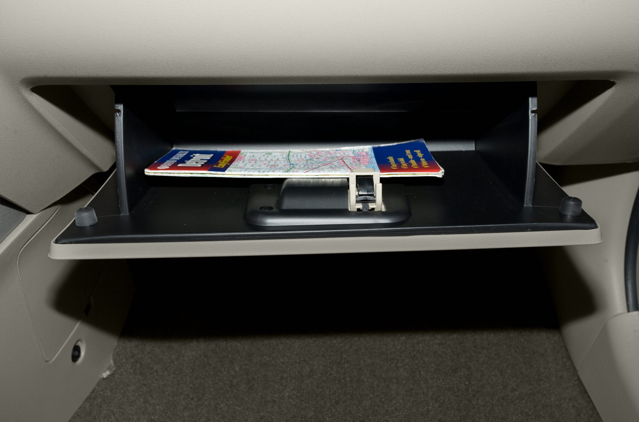 Open glove compartment with map inside