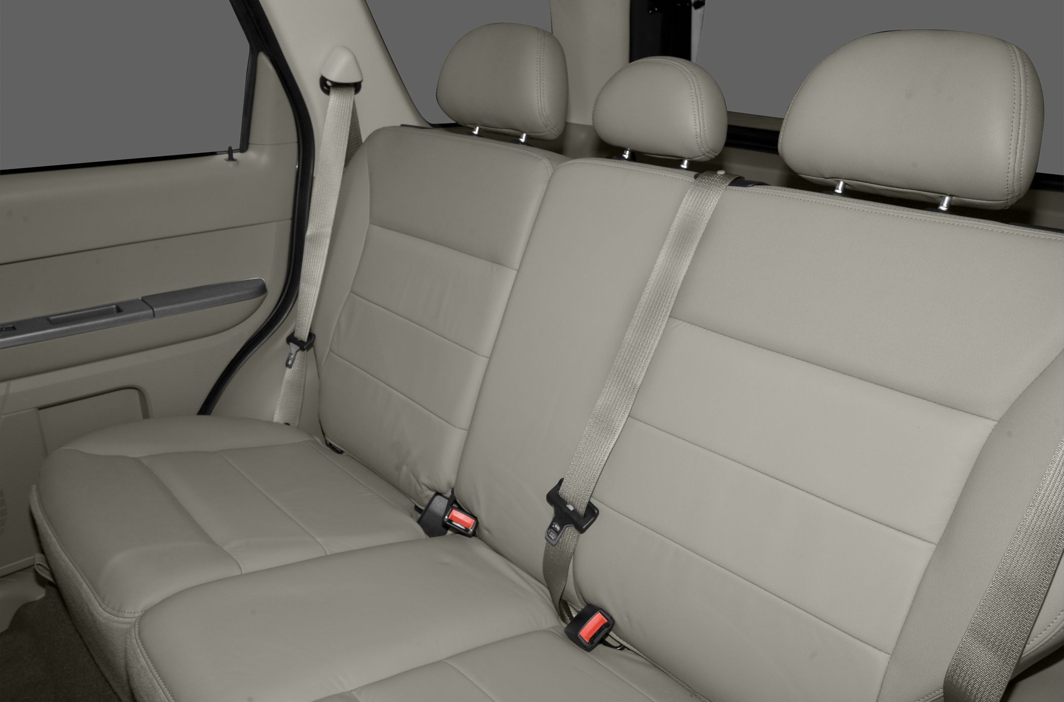 Beige leather rear seats with headrests and seat belts