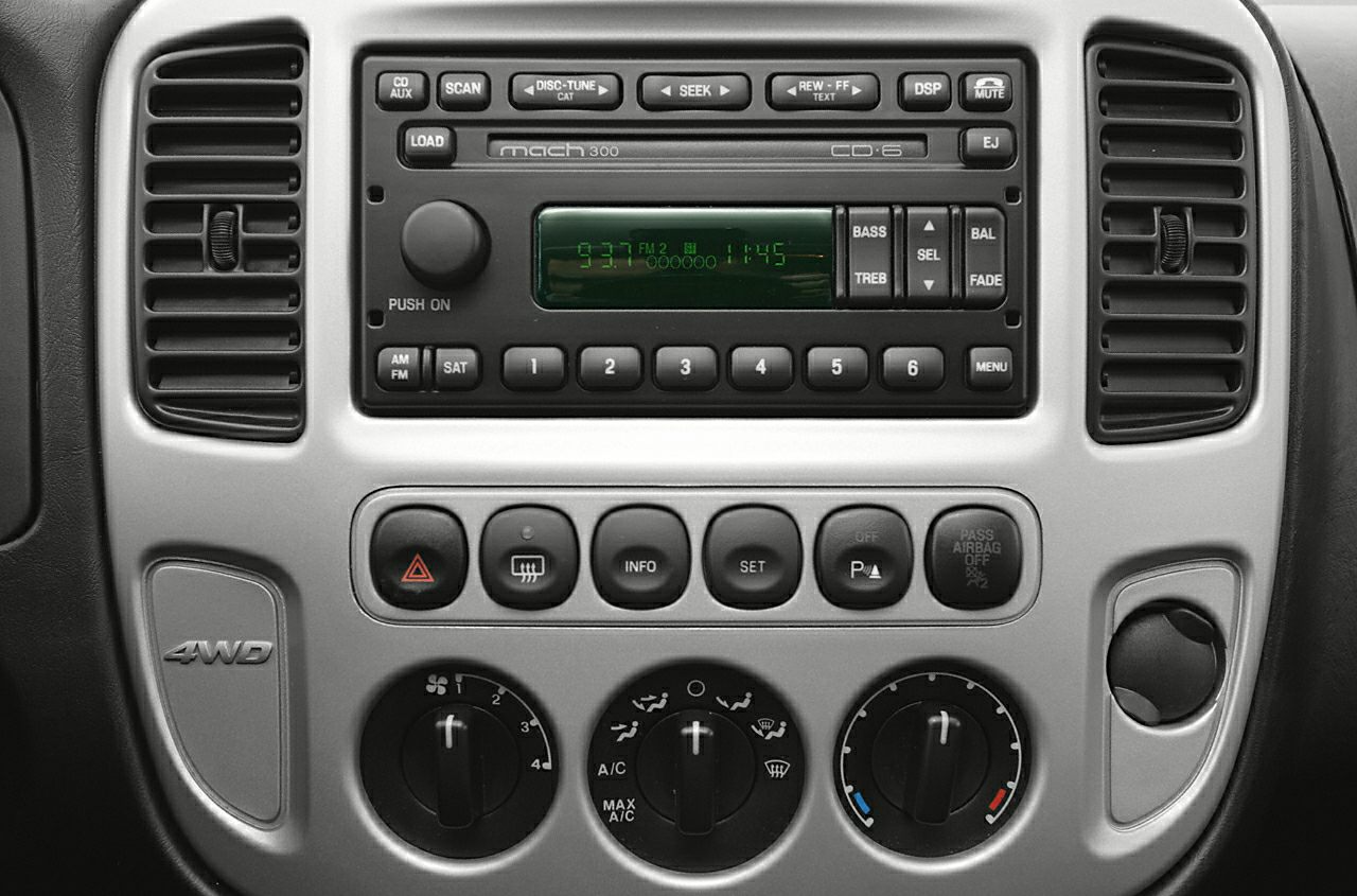 Car dashboard radio with climate control dials and 4WD badge