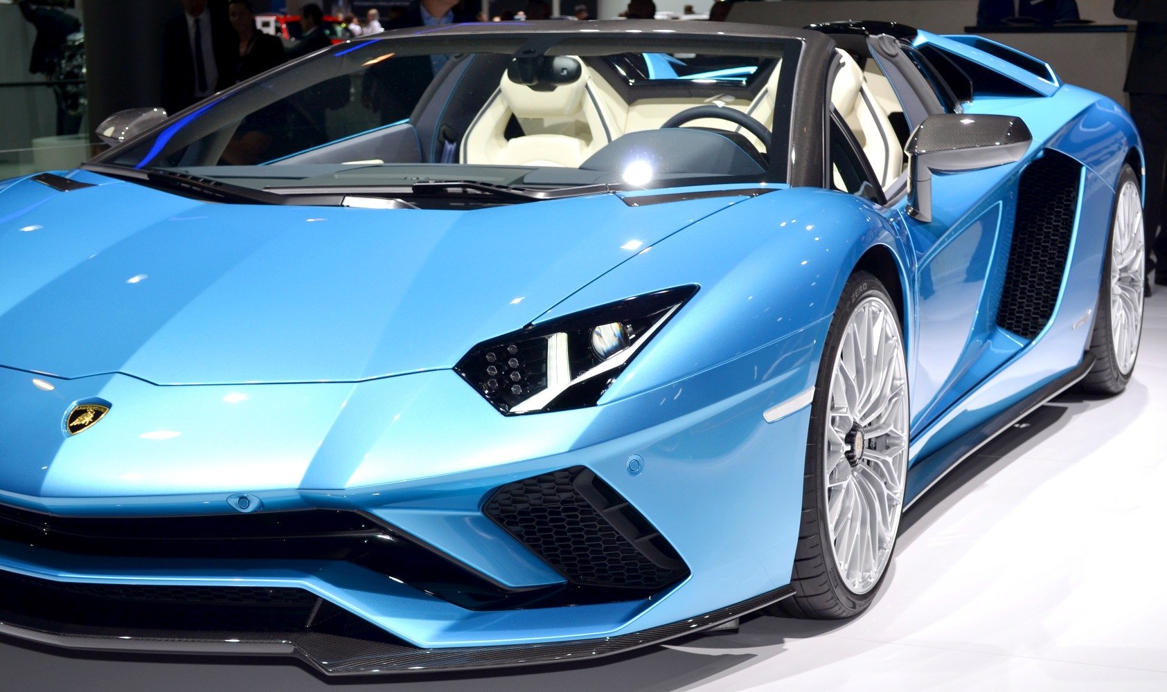 Front end with sharp headlights and detailed alloy wheels.