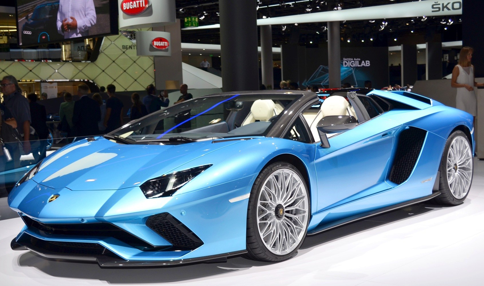 Blue convertible with aggressive aerodynamic styling and multi-spoke alloy wheels