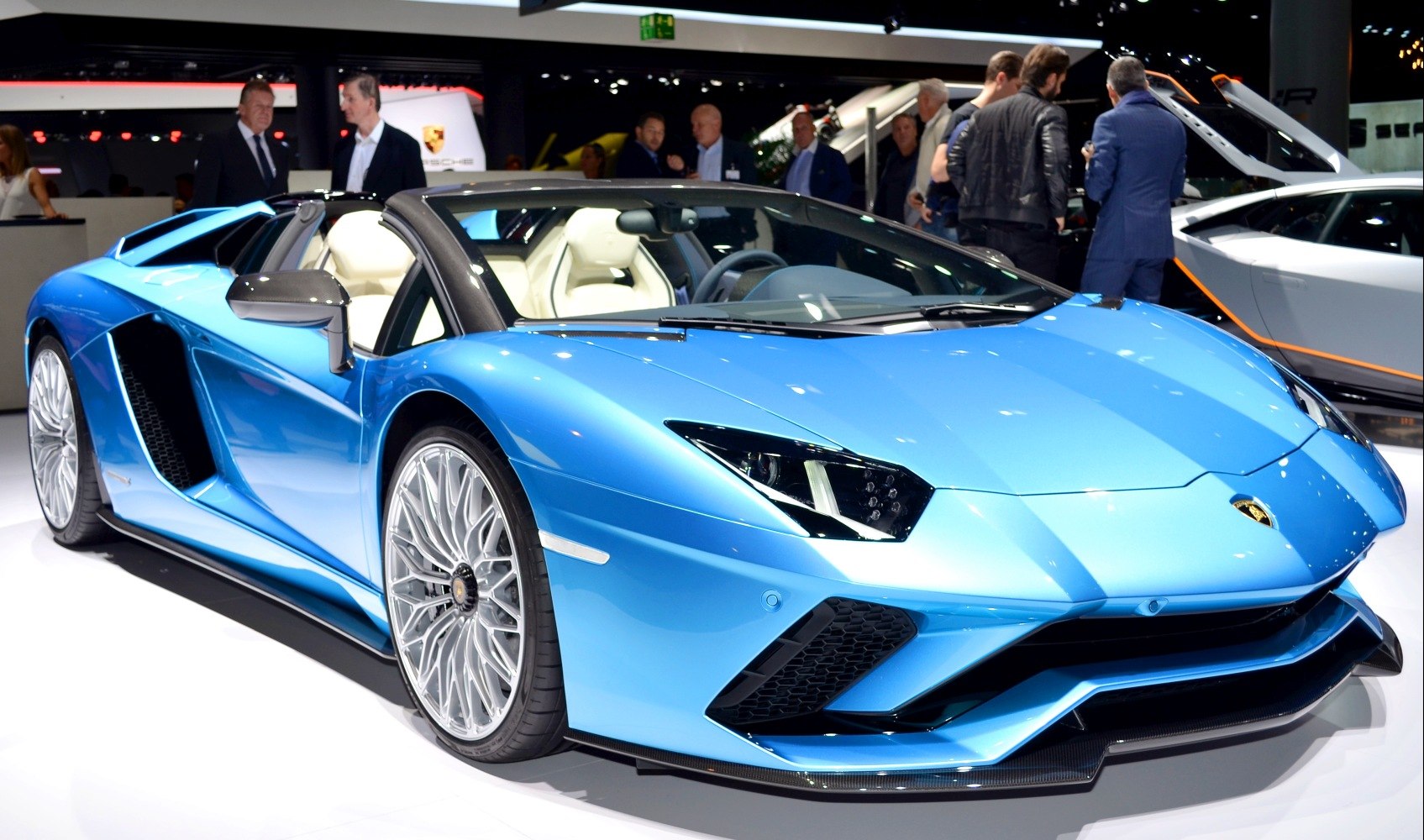 Blue convertible sports car with white interior and alloy wheels